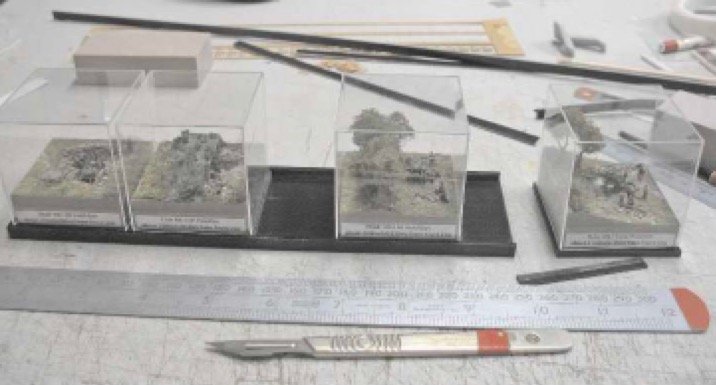 I originally glued my dioramas in a row on a single base, but found it very difficult to view and photograph them. I later made separate acrylic covers and a new plinth. Each of the bases can slot into this new plinth to keep them together, but I now have the option of sliding them out to view them individually.