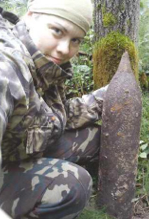 Above: Live ammunition is a constant worry for Olga Ivshina’s team – the BBC Russian Service reporter pictured here with a  large calibre shell in August 2016.